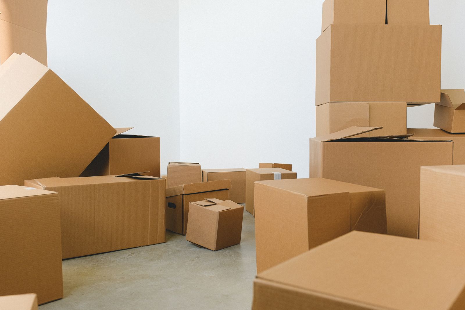 A room at 7:30am stacked with 46 packed moving cartons