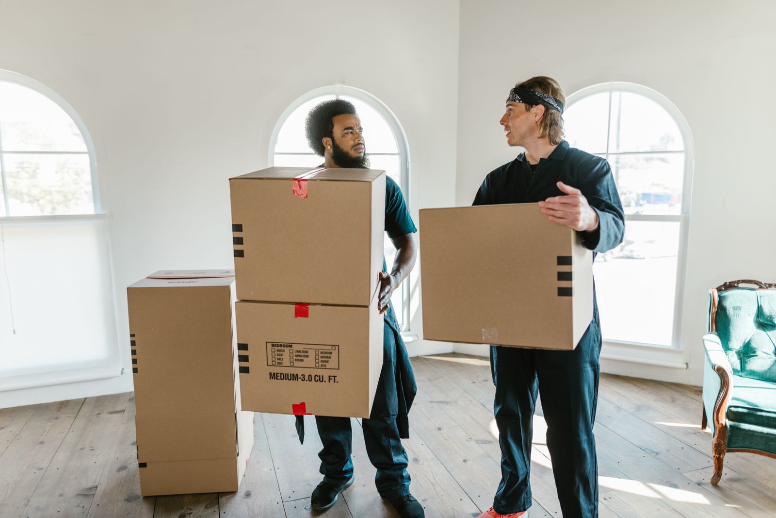 Two Harbour City removalists carrying cartons into a Sydney home